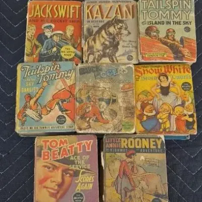 Collection of eight vintage Big Little Books from the 1930s and 1940s, featuring titles like Tailspin Tommy, Buck Rogers, and Snow White,...