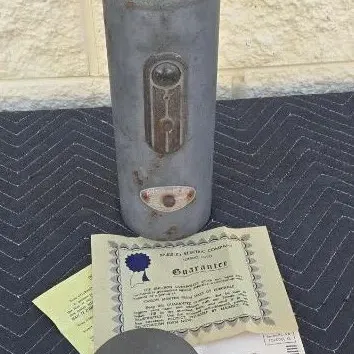 Vintage Markel Electric Products heater element with its original metal canister, lid, and paper guarantee certificate.