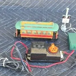 Vintage Bachmann G scale trolley set components, including a green and orange trolley car, power pack controller, and two railroad...