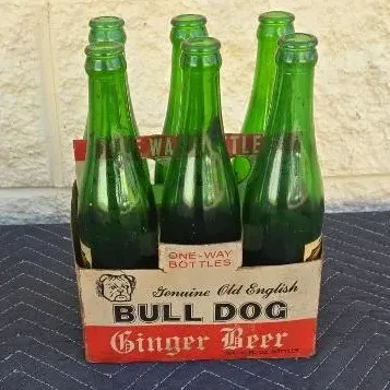 Vintage six-pack of Bull Dog Ginger Beer in green glass bottles, complete with its original cardboard carrying carton.