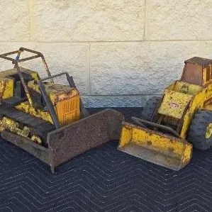 Pair of vintage Tonka pressed steel construction toys, including a crawler tractor bulldozer and a front-end wheel loader, showing...