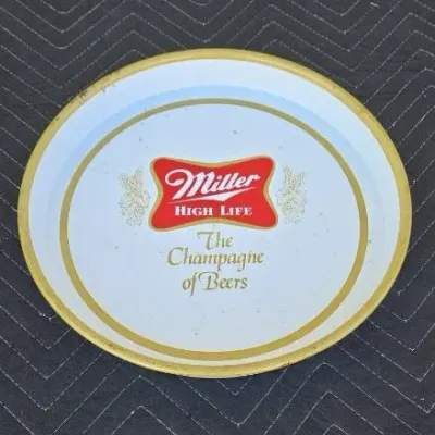 Vintage Miller High Life metal beer tray featuring "The Champagne of Beers" slogan and classic logo, showing minor wear and...