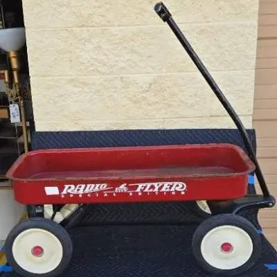 Vintage Radio Flyer Special Edition red metal wagon, showing some wear and light rust consistent with age and use.