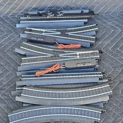 Assorted Bachmann HO scale EZ Track pieces, including curved, straight, and crossover sections with integrated roadbed.