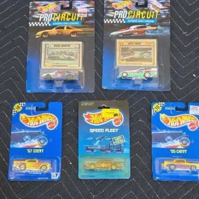 Five vintage Hot Wheels die-cast toy cars in their original blister pack packaging, including Pro Circuit and Speed Fleet series from the...