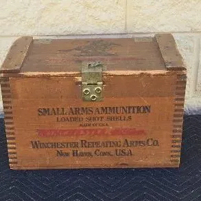 Vintage Winchester Repeating Arms Co. wooden ammunition box with finger-jointed corners and a brass latch.