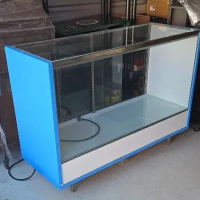 Commercial glass display case featuring bright blue side panels, a white base, and a metal frame, suitable for retail or collectible...
