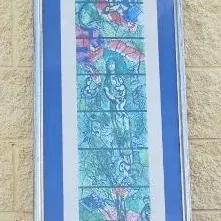 Framed Marc Chagall stained glass window exhibition poster, featuring a tall, arched design in vibrant blue and green tones.