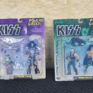 Two vintage KISS Psycho Circus action figures in original blister packaging, featuring Paul Stanley as "The Jester" and Peter...