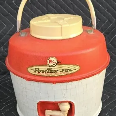 Vintage Poloron FunTex Jug insulated beverage dispenser, featuring a red and white plastic body with a carrying handle and bottom spout,...