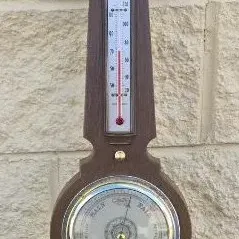 Vintage Airguide banjo-style wall weather station featuring a barometer, thermometer, and humidity gauge in a dark wood case.