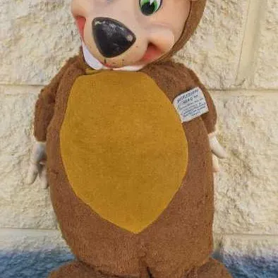 Vintage Knickerbocker Yogi Bear plush toy with a molded vinyl face, showing some wear and tear on the feet, circa 1960s.