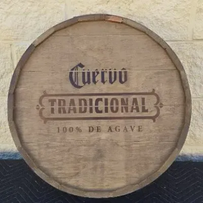Jose Cuervo Tradicional tequila barrel head wall hanging, featuring stenciled branding on rustic weathered wood.