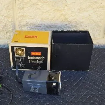 Vintage Kodak Instamatic Movie Light with its original box and packaging, circa 1960s.