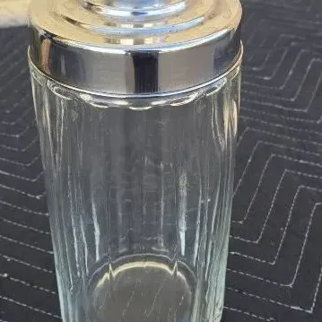 Vintage ribbed clear glass canister with a tiered chrome lid, suitable for kitchen or bathroom storage.