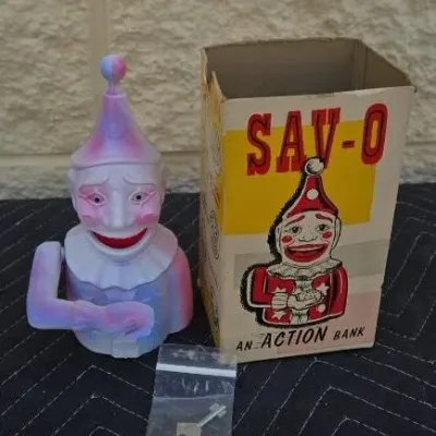 Vintage Sav-O mechanical clown action bank, complete with its original illustrated box and key.