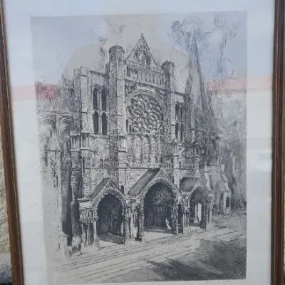 Framed architectural etching depicting a Gothic cathedral facade, presented in a simple wooden frame with a white mat.