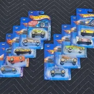 Collection of vintage Hot Wheels die-cast toy cars, individually sealed in their original blister packs, circa early 2000s.
