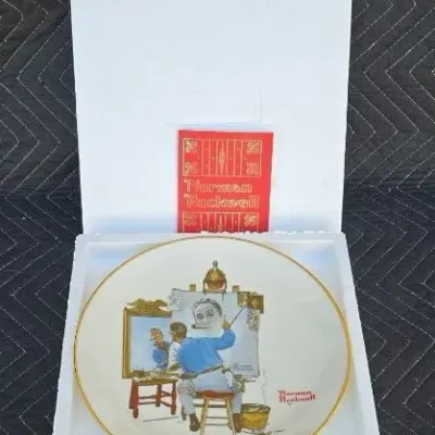 Norman Rockwell collector plate featuring "Triple Self-Portrait," complete with its original styrofoam packaging and...