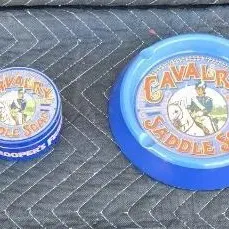 Vintage Cavalry Brand Saddle Soap tin and matching blue plastic ashtray, featuring a trooper on horseback graphic.