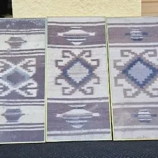 Triptych of framed textile art panels featuring Southwestern-style geometric patterns in muted purple, grey, and blue tones.