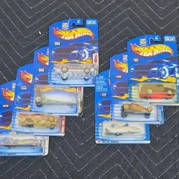 Collection of seven vintage Hot Wheels die-cast toy cars, individually sealed in their original blister packs, circa early 2000s.