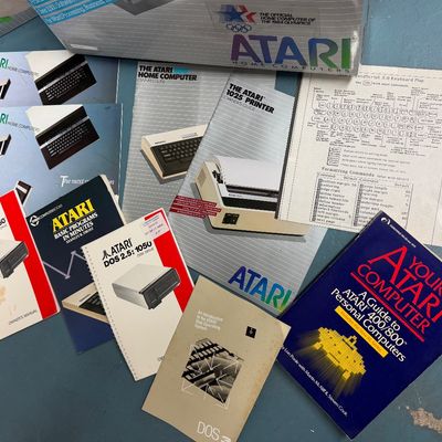 Sale Photo Thumbnail #2: Vintage Atari home computer manuals and guides, including owners guides for the Atari 800 and 1025 printer, DOS 2.5: 1050 disk drive manuals, and "Your Atari Computer" guide book, circa 1980s.