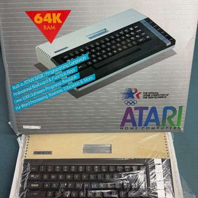 Sale Photo Thumbnail #9: Vintage Atari 800XL home computer with 64K RAM, shown in its original retail box with styrofoam packaging, circa 1983.