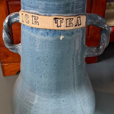 Sale Photo Thumbnail #10: Handmade blue glazed stoneware iced tea dispenser featuring twisted clay handles, a matching lid, and a metal spigot.