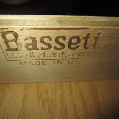 Bassett Furniture maker's mark branded into the wooden interior of a drawer, indicating American-made mid-century construction.