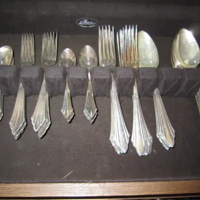 Vintage silver-plated flatware set with a classic fan-shaped handle design, organized in a Pacific Silvercloth lined storage chest.