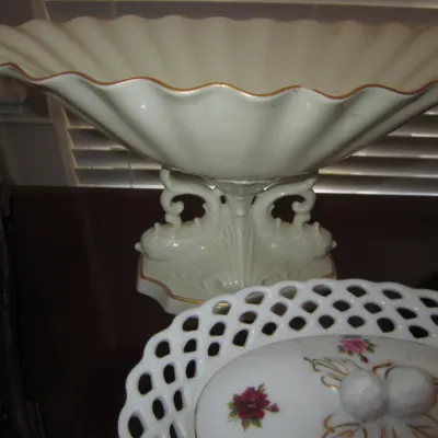 Vintage Lenox porcelain pedestal bowl with a fluted, scalloped rim and gold trim, shown alongside a reticulated porcelain lid with rose...