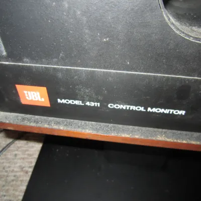 Vintage JBL Model 4311 Control Monitor speaker, showing the front faceplate and logo with some surface dust.