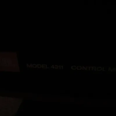 Vintage JBL Model 4311 Control Monitor speaker badge, showing the logo and model text on a dark background.