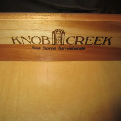 Knob Creek maker's mark branded into the wooden interior of a furniture drawer.