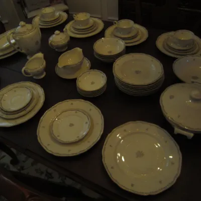 Vintage Haviland Limoges porcelain dinnerware set featuring delicate floral patterns and gold trim, including plates, bowls, teacups, and...