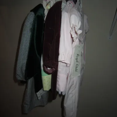 Sale Photo Thumbnail #101: Assortment of vintage children's clothing hanging in a closet, including a pink Royal Child outfit with tags, a velvet dress, and a houndstooth coat.