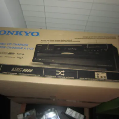 Onkyo DX-C390 6-disc CD changer, presented in its original cardboard packaging.