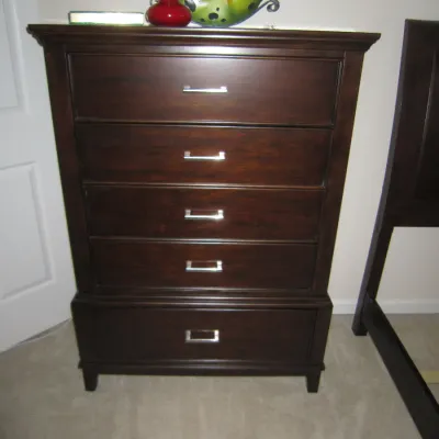Contemporary dark wood five-drawer chest of drawers with sleek silver-toned bar pulls.