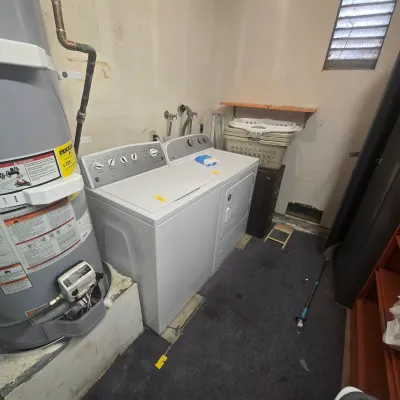 Kenmore top-load washing machine and Whirlpool front-load dryer set, showing some wear, available for a Buy It Now price of $325.