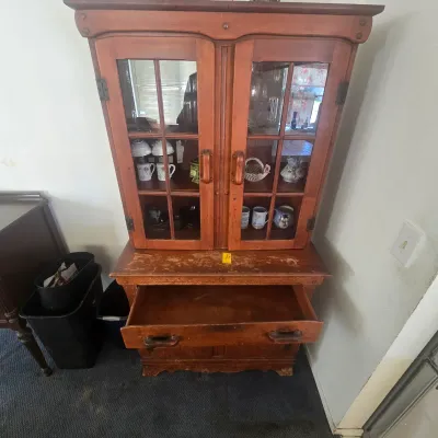 Vintage wooden hutch with glass-front cabinet doors, a lower drawer, and visible surface wear, available for a buy-it-now price of $150.