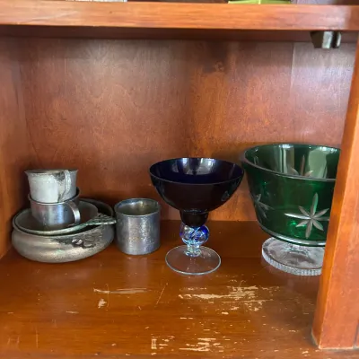 Assorted vintage glassware and metalware, including a cobalt blue goblet, a green cut-to-clear glass bowl, and small pewter cups,...