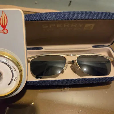Sale Photo Thumbnail #139: Lot of misc stuff including cast iron pan ashtray, vintage sunglasses and a pair of new in package Camel branded zippo lighters