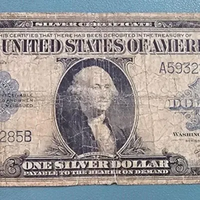 Series of 1923 United States one dollar silver certificate, showing heavy creasing and wear consistent with age.