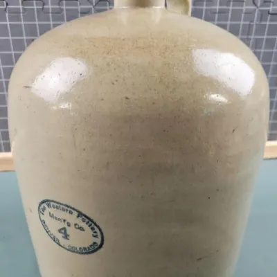 Vintage 4-gallon stoneware jug from The Western Pottery Manufacturing Company of Denver, Colorado, featuring a salt-glazed finish and a...