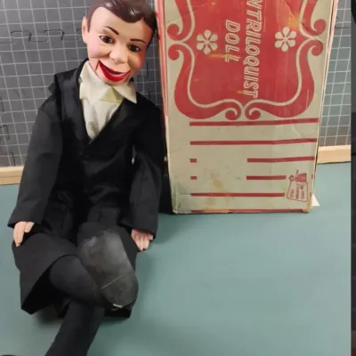 Vintage Goldberger Charlie McCarthy ventriloquist doll in a black tuxedo, shown with its original cardboard box.