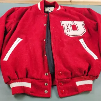 Vintage red wool University of Utah letterman jacket with white trim, snap closures, and a large chenille "U" patch on the chest.