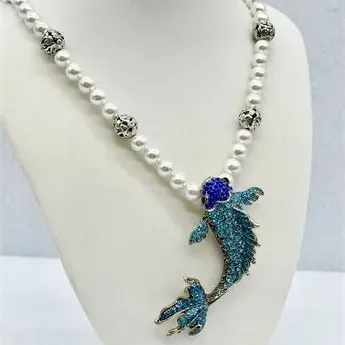 Sale Photo Thumbnail #16: Faux pearl necklace featuring a large, rhinestone-encrusted koi fish pendant in shades of blue and turquoise, accented with decorative silver-tone metal beads.