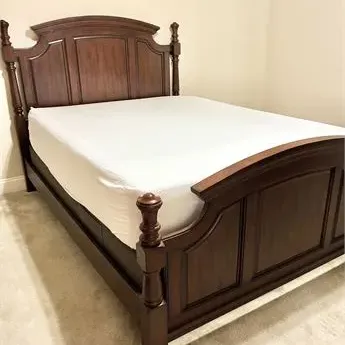 Sale Photo Thumbnail #28: Traditional dark wood queen-size bed frame featuring a paneled headboard and footboard with turned corner posts.