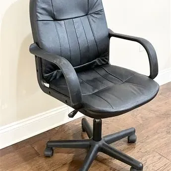 Sale Photo Thumbnail #25: Black faux leather office swivel chair with integrated armrests and a five-star caster base.
